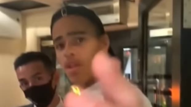 Mason Greenwood waves his hand in front of a cameraphone after being goaded by a man filming him