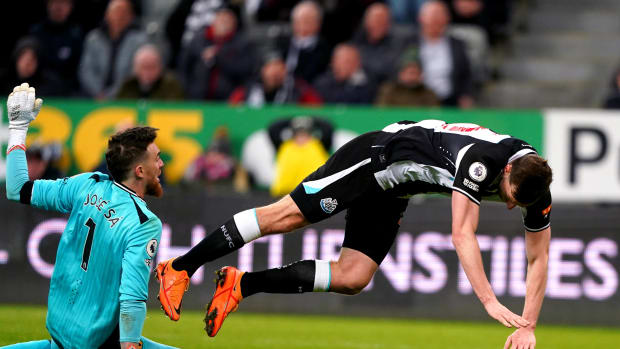 Newcastle striker Chris Wood falls after being fouled by Wolves goalkeeper Jose Sa during a Premier League game in April 2022