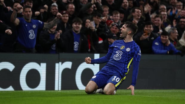 Christian Pulisic slides on his knees after scoring for Chelsea against Lille