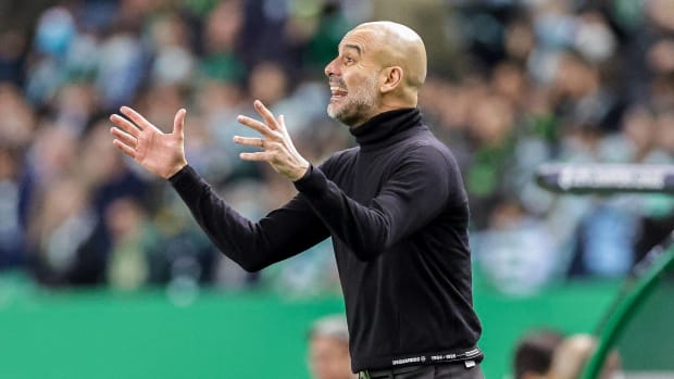 Pep Guardiola gestures from the sideline during Man City's 5-0 win at Sporting Lisbon in February 2022