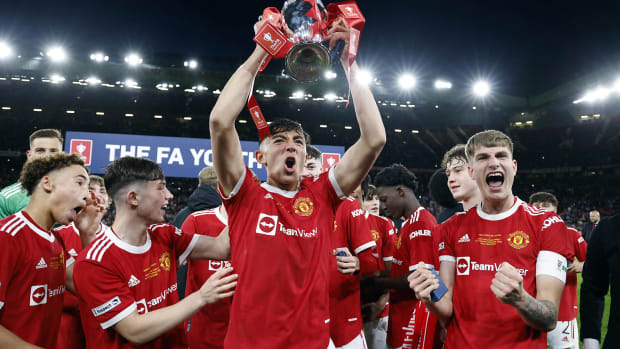 Manchester United's players celebrate winning the 2021/22 FA Youth Cup after beating Nottingham Forest 3-1 in the final at Old Trafford