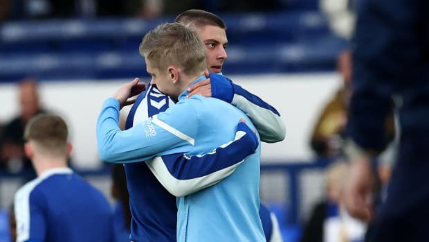 Vitalli Mykolenko of Everton and Oleksandr Zinchenko of Man City pictured hugging before a game at Goodison Park