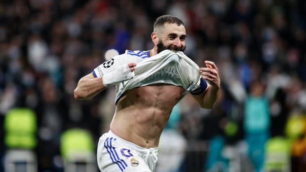 Karim Benzema celebrates by lifting his shirt after scoring for Real Madrid against PSG