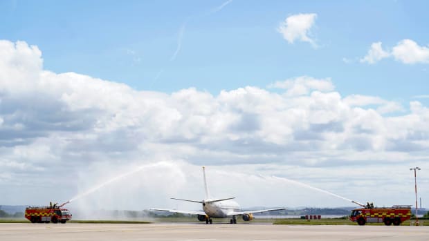 A plane carrying the Liverpool team to Paris for the Champions League final is pictured being given a water salute by the fire brigade at John Lennon Airport
