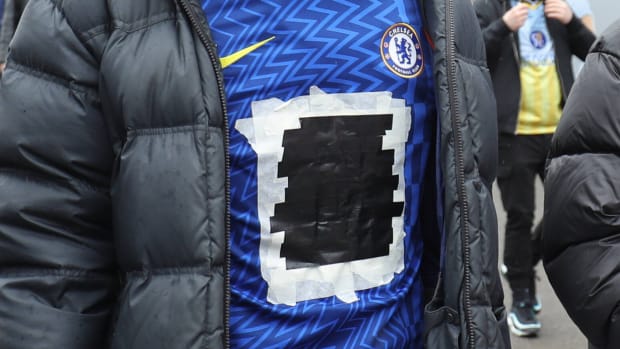 Chelsea fan wears jersey with tape covering Three logo