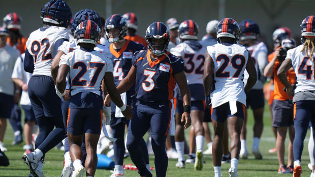 Denver Broncos quarterback Russell Wilson (3) greets cornerback Damarri Mathis (27) during training camp at the UCHealth Training Center.