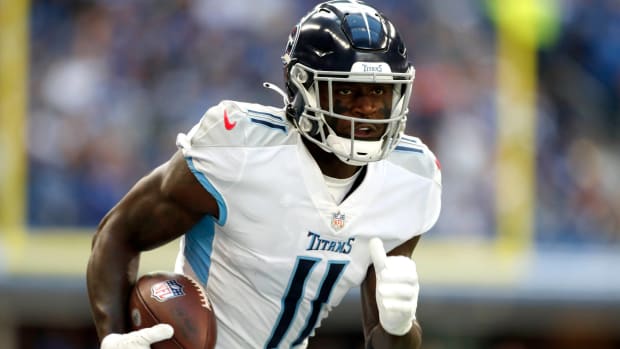 Titans wide receiver A.J. Brown runs with the ball during a game.