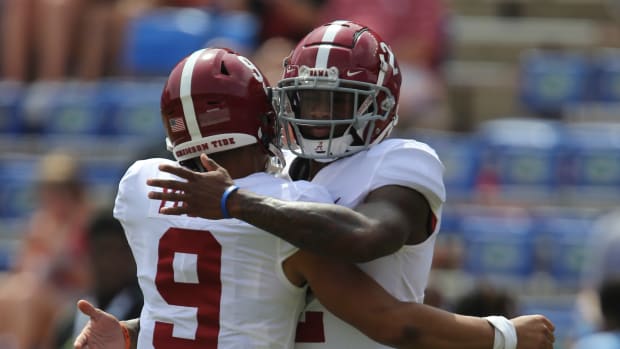 Alabama Crimson Tide quarterbacks Bryce Young (9) and Jalen Milroe (2) embrace during warm ups before the game against the Florida Gators at Ben Hill Griffin Stadium.