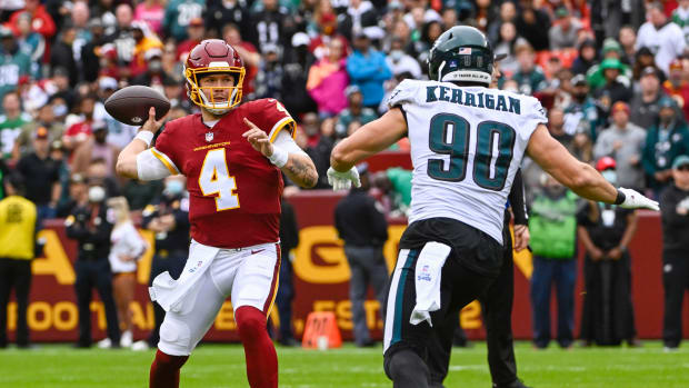 Jan 2, 2022; Landover, Maryland, USA; Washington Football Team quarterback Taylor Heinicke (4) attempts a pass as Philadelphia Eagles defensive end Ryan Kerrigan (90) rushes during the first half at FedExField.