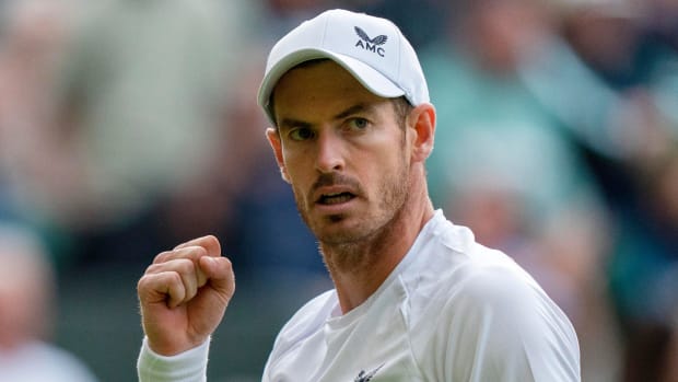 Andy Murray reacts to a point during his second round match against John Isner at Wimbledon 2022.