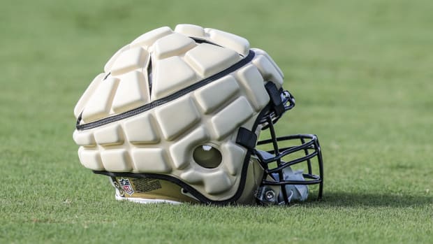 Jul 29, 2022; Metairie, LA, USA; New Orleans Saints helmet on the ground with a Guardian Cap on the top during training camp at Ochsner Sports Performance Center.