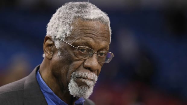 NBA legend Bill Russell stares into the camera.