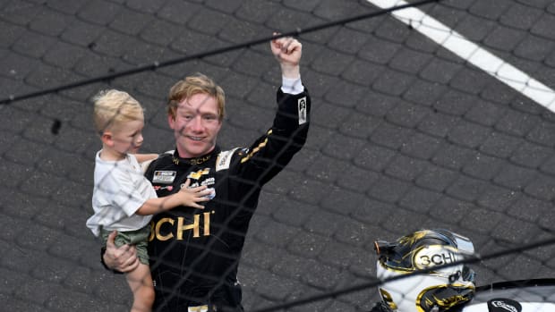 NASCAR Cup Series driver Tyler Reddick holds up his son, Beau, on Sunday after winning the Verizon 200 at the Brickyard at Indianapolis Motor Speedway. Photo: USA Today Sports / Bob Goshert.