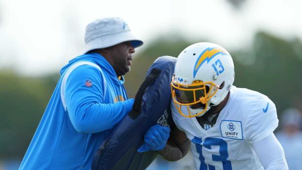 Aug 1, 2022; Costa Mesa, CA, USA; Los Angeles Chargers wide receivers coach Chris Beatty (left) and receiver Keenan Allen (13) during training camp at the Jack Hammett Sports Complex. Mandatory Credit: Kirby Lee-USA TODAY Sports