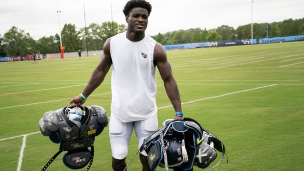 Tennessee Titans rookie cornerback Roger McCreary (21) carries the helmets and pads of veteran players after a training camp practice at Ascension Saint Thomas Sports Park.