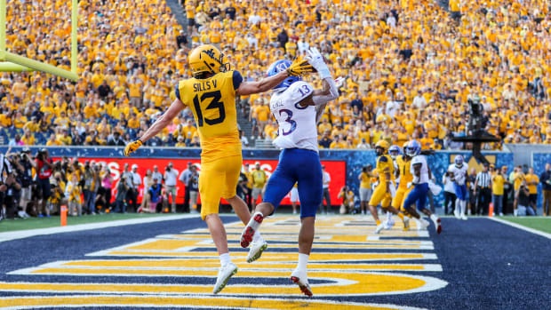 Oct 6, 2018; Morgantown, WV, USA; Kansas Jayhawks cornerback Hasan Defense (13) intercepts a pass against the West Virginia Mountaineers in the end zone during the first quarter at Mountaineer Field at Milan Puskar Stadium. Mandatory Credit: Ben Queen-USA TODAY Sports