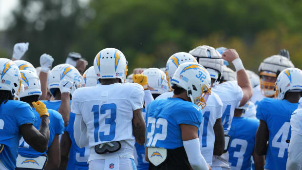 Aug 1, 2022; Costa Mesa, CA, USA; Los Angeles Chargers players huddle during training camp at the Jack Hammett Sports Complex. Mandatory Credit: Kirby Lee-USA TODAY Sports