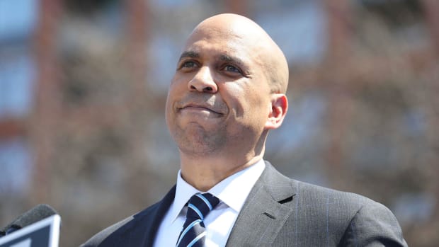 Cory Booker stands outside