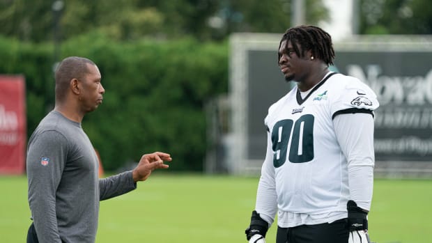Jordan Davis gets instruction from a member of the Eagles coaching staff during training camp