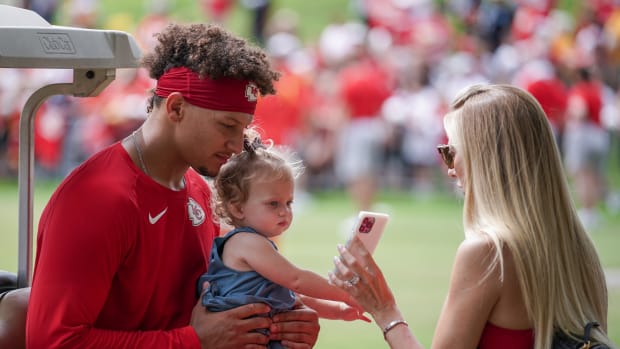 Jul 29, 2022; St. Joseph, MO, USA; Kansas City Chiefs quarterback Patrick Mahomes (15) and wife Brittany interact with their daughter Sterling after training camp at Missouri Western State University. Mandatory Credit: Denny Medley-USA TODAY Sports