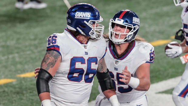 Nov 2, 2020; East Rutherford, New Jersey, USA; New York Giants guard Shane Lemieux (66) celebrates after spiking the ball from a rushing touchdown by running back Wayne Gallman (22), not pictured, with guard Nick Gates (65) during the first half at MetLife Stadium.