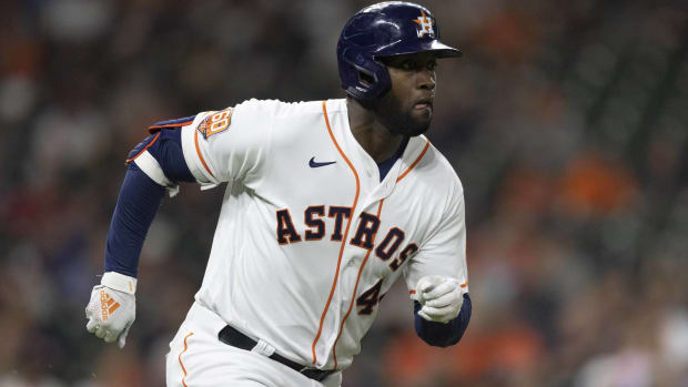 Astros designated hitter Yordan Álvarez runs to first base after hitting a ball.