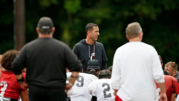 Cincinnati Bearcats head coach Luke Fickell calls a huddle to end the morning session during practice at the Higher Ground training facility in West Harrison, Ind., on Monday, Aug. 9, 2021. Cincinnati Bearcats Football Camp