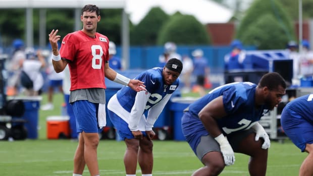 Jul 29, 2022; East Rutherford, NJ, USA; New York Giants quarterback Daniel Jones (8) directs his team as running back Saquon Barkley (26) watches during training camp at Quest Diagnostics Training Facility.