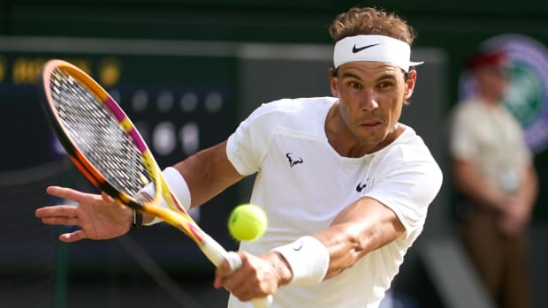 Rafael Nadal (ESP) returns a shot during his quarter finals men’s singles match against Taylor Fritz (USA) at the 2022 Wimbledon tournament.
