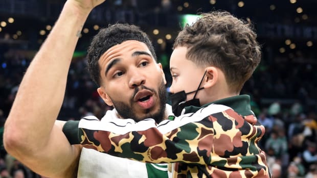 Boston Celtics forward Jayson Tatum (0) holds his son Deuce after game two of the second round for the 2022 NBA playoffs.