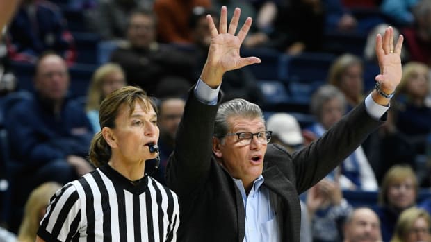 Connecticut head coach Geno Auriemma gestures to his team as official Dee Kantner, left, watches play during the second half an NCAA college basketball game against Central Florida, Tuesday, Jan. 9, 2018.
