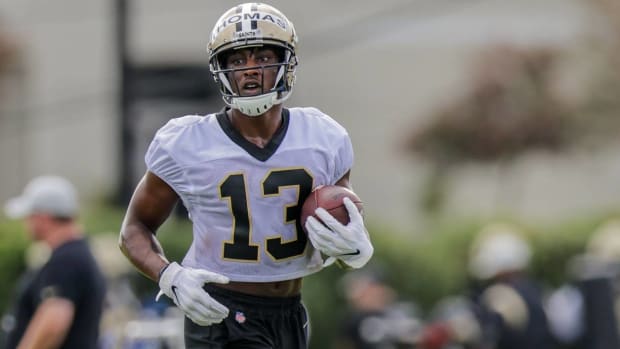 Saints wide receiver Michael Thomas carries a ball during practice in training camp.