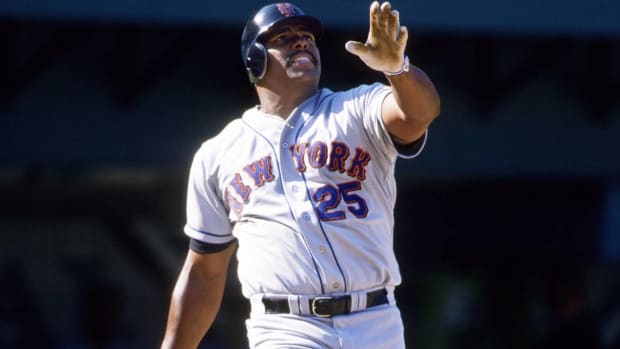 Former Mets hitter Bobby Bonilla looks at a fly ball at the plate.