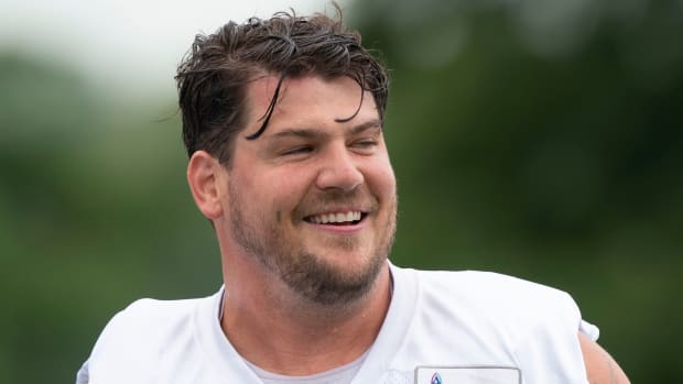 Tennessee Titans offensive tackle Taylor Lewan (77) laughs with teammates during a training camp practice at Saint Thomas Sports Park Thursday, July 28, 2022, in Nashville, Tenn.