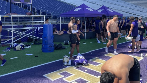 The Huskies cool off in ice baths set up on the field.