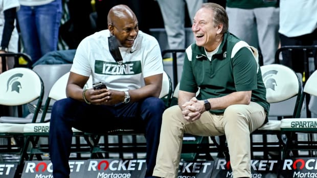 Michigan State’s basketball coach Tom Izzo, right, and football coach Mel Tucker talk before the Spartans basketball game against Purdue.