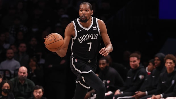 Nets forward Kevin Durant (7) dribbles up court during a game against the Hornets.