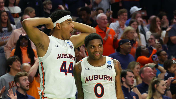 GREENVILLE, SOUTH CAROLINA - MARCH 18: Dylan Cardwell #44 and K.D. Johnson #0 of the Auburn Tigers react after Jabari Smith #10's dunk against the Jacksonville State Gamecocks during the second half in the first round game of the 2022 NCAA Men's Basketball Tournament at Bon Secours Wellness Arena on March 18, 2022 in Greenville, South Carolina. (Photo by Kevin C. Cox/Getty Images)