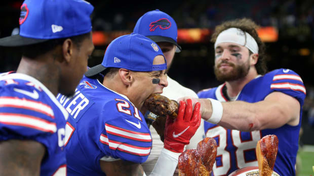 Jordan Poyer of the Bills eats a turkey leg after the team wins a Thanksgiving game.