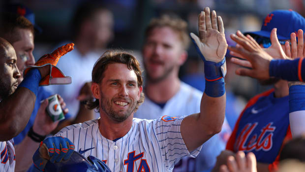 Aug 7, 2022; New York City, New York, USA; New York Mets second baseman Jeff McNeil (1) celebrates with teammates after scoring a run on a wild pitch during the fifth inning against the Atlanta Braves at Citi Field.