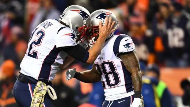 Tom Brady and James White celebrate during a Patriots game at the Broncos.