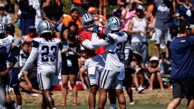 Dallas Cowboys quarterback Dak Prescott (4) with running back Tony Pollard (20) during a joint training camp with the Denver Broncos at the UCHealth Training Center.