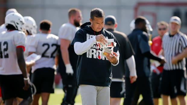 Bearcats head coach Luke Fickell checks notes during the first day of preseason training camp at the University of Cincinnati s Sheakley Athletic Complex in Cincinnati on Wednesday, Aug. 3, 2022. Bearcats Football Camp