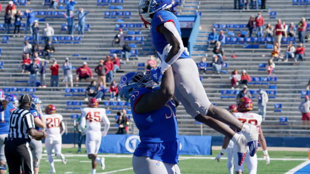 Oct 31, 2020; Lawrence, Kansas, USA; Kansas Jayhawks safety Kenny Logan Jr. (1) celebrates with offensive lineman Armaj Adams-Reed (55) after returning a kickoff for a touchdown during the second half against the Iowa State Cyclones at David Booth Kansas Memorial Stadium. Mandatory Credit: Denny Medley-USA TODAY Sports