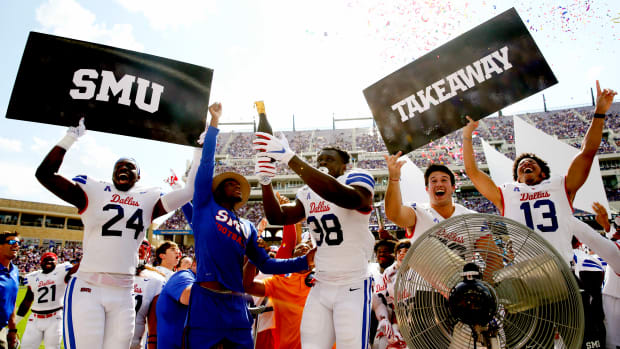 Southern Methodist Mustangs defensive end Toby Ndukwe (38) pops a champagne bottle to release confetti after a turnover during the first half against the TCU Horned Frogs at Amon G. Carter Stadium.