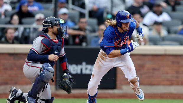 May 3, 2022; New York City, New York, USA; New York Mets center fielder Travis Jankowski (16) runs out an infield single against the Atlanta Braves during the sixth inning at Citi Field.