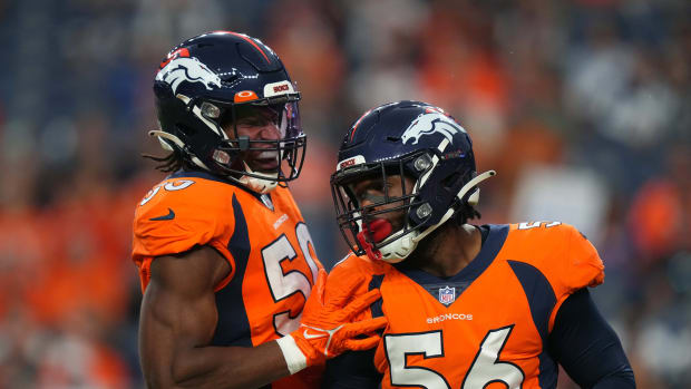 Denver Broncos linebacker Baron Browning (56) and linebacker Jonas Griffith (50) celebrate a play in the first quarter against the Dallas Cowboys at Empower Field at Mile High.