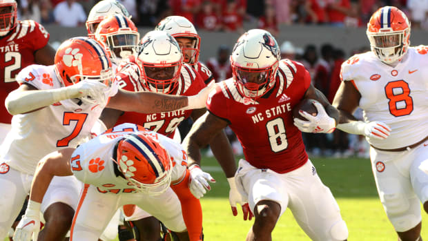 North Carolina State Wolfpack running back Ricky Person Jr. (8) runst the ball during the first half against th Clemson Tigers at Carter-Finley Stadium.