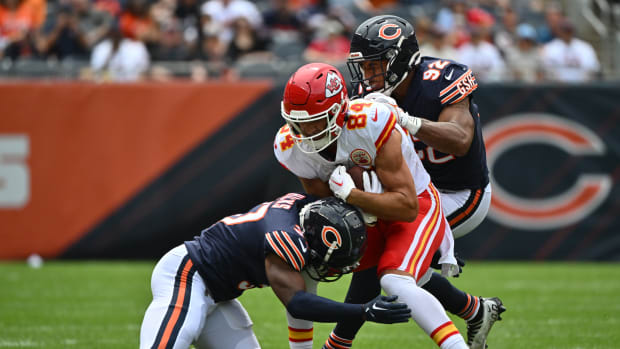 Aug 13, 2022; Chicago, Illinois, USA; Kansas City Chiefs wide receiver Justin Watson (84) is brought down after a short pass reception by Chicago Bears defensive back Elijah Hicks (37), bottom, and linebacker Caleb Johnson (92) in the second quarter at Soldier Field. Mandatory Credit: Jamie Sabau-USA TODAY Sports