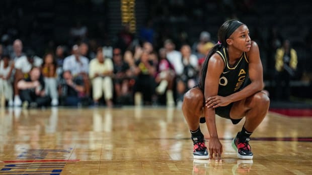 Las Vegas Aces guard Jackie Young rests on the court in a game against the Seattle Storm.